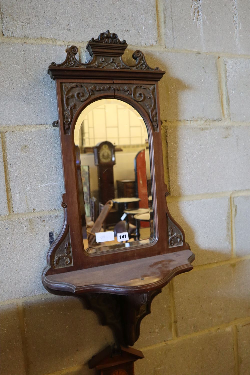 A late Victorian mirrored wall bracket and two wheel barometers